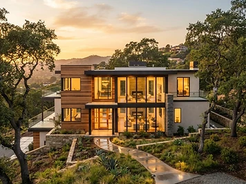 Modern custom home with wood and stucco facade in the Walnut Creek hills at golden hour