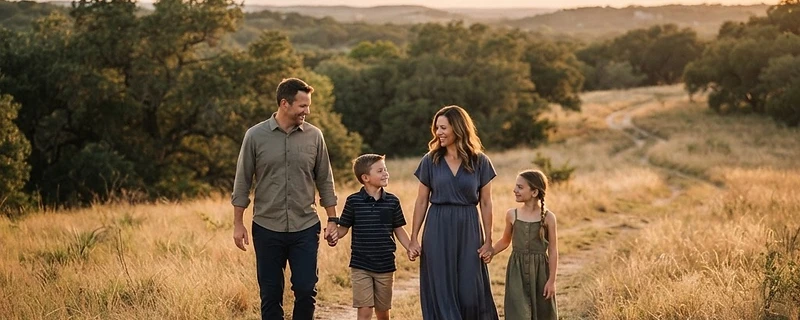 Family walking together through a sunlit Texas field at golden hour