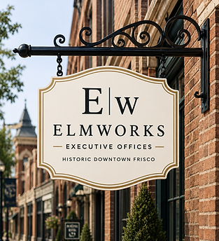 The ElmWorks executive offices blade sign mounted on a red brick wall in Historic Downtown Frisco