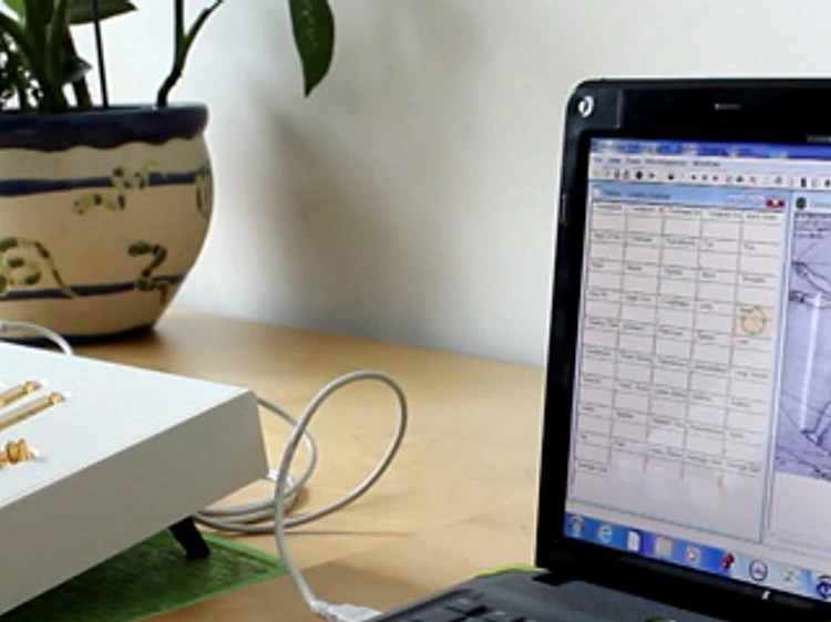 The biofeedback system reading a client's hand