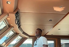 Captain at the helm in the bridge of a large yacht