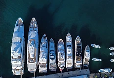Aerial top-down view of yachts docked side-by-side at a Caribbean marina with deep turquoise-blue water