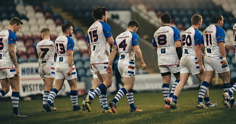 Rugby team in custom Impact teamwear under floodlights