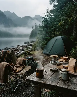 Campsite by a foggy lake with a steaming pour-over coffee
