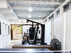 Fitness & Recreation at NERS House A simple indoor space for exercise and recreation, equipped with fitness machines and table tennis.