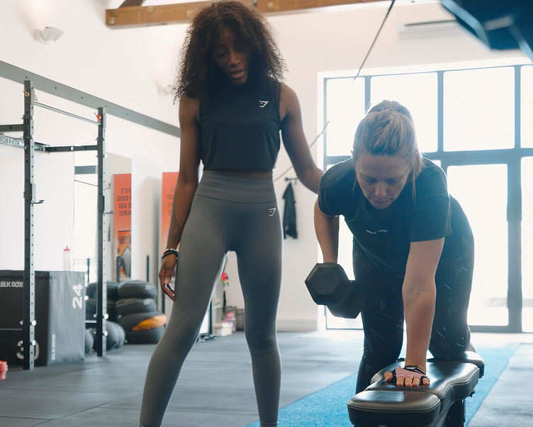 A woman in her 40s performing a controlled strength movement