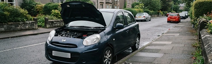 Quiet Renfrewshire residential street with a car parked at the kerb, bonnet open