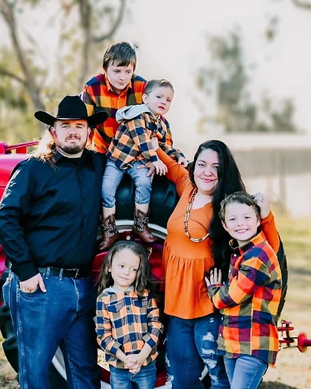 Dacoda Quinn with his wife and four sons in a 2023 family portrait