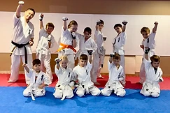 Training group with raised fists in rows on the mat at Shinzen Dojo Berlin