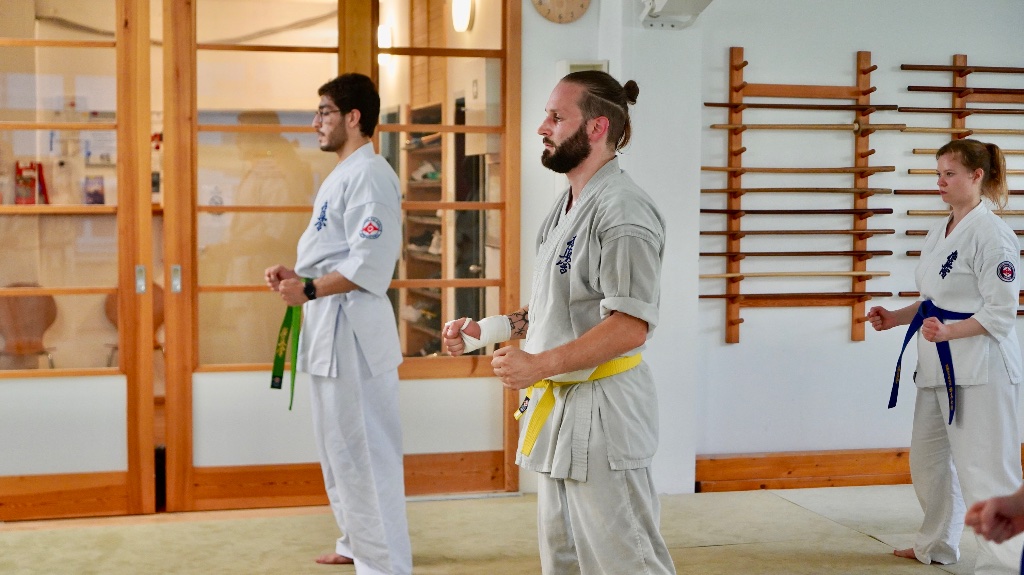 Three adults in basic stance at Shinzen Dojo Berlin
