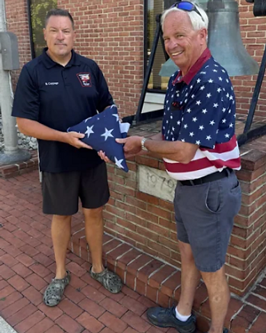All State Building Company roofing crew in Chestertown, MD holding a folded American flag