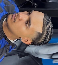 Client with cornrow braids and sharp fade, A-List branded cape