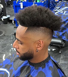 Client with high fade and textured afro top, A-List branded cape