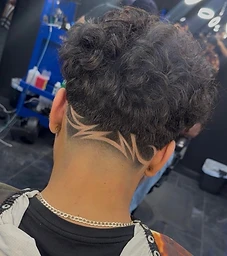 Curly top with tribal design carved into the nape fade