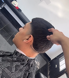 Short tapered cut with crisp nape line, profile view