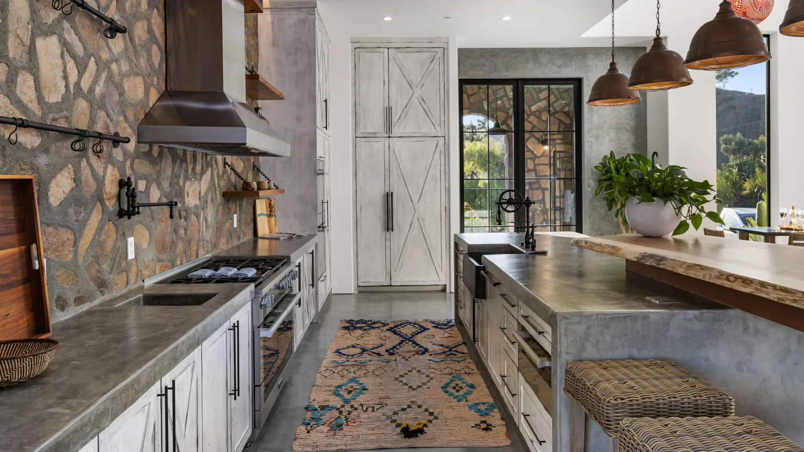 Finished custom kitchen with stone, metal, wood, and crafted cabinetry