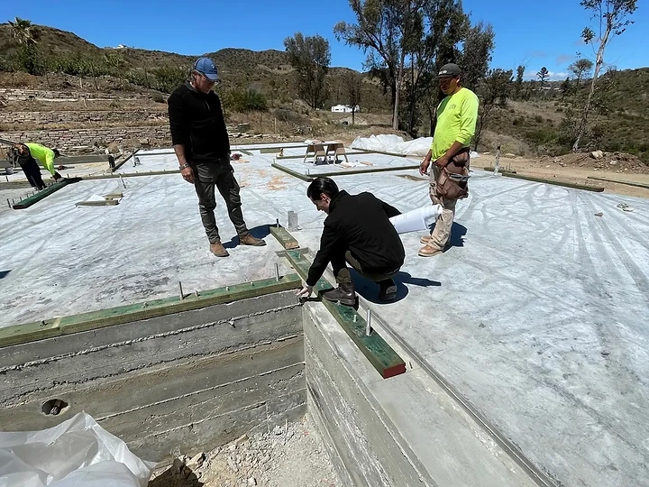 Apel Design team reviewing site layout and framing on a project site