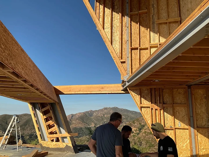 The team reviewing the cantilevered framing at The Aviator