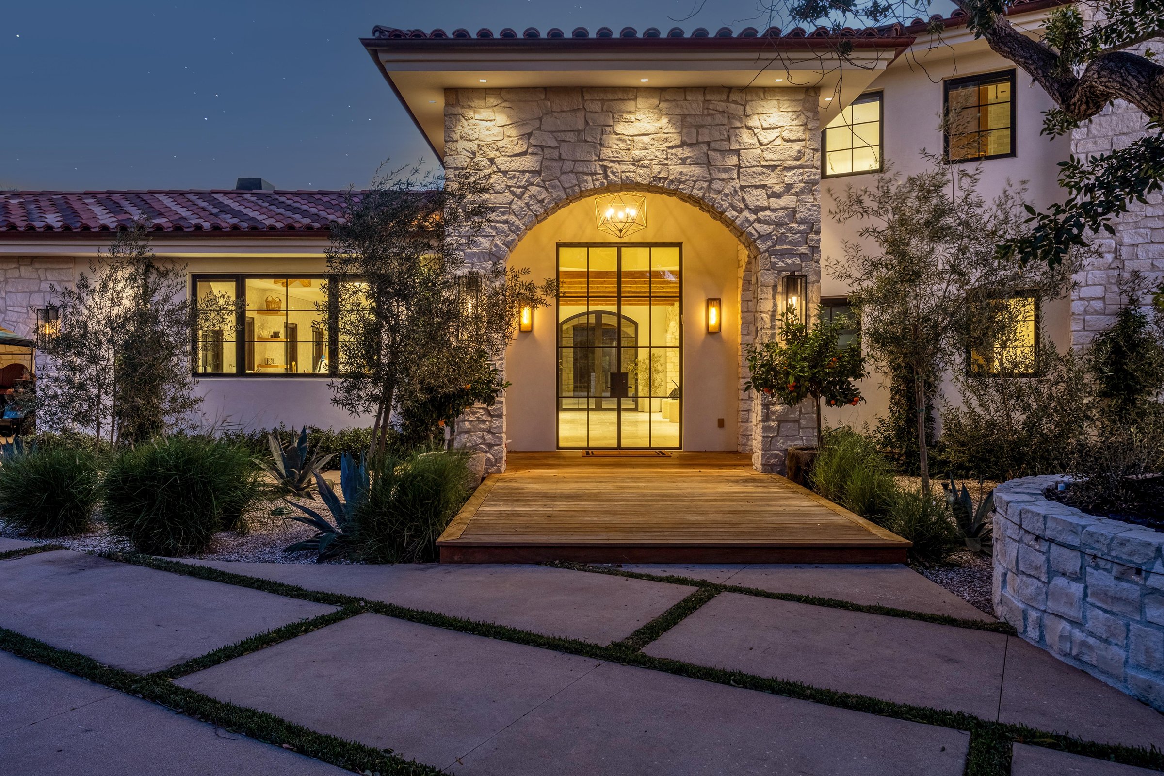 The stone entry pavilion and its arched steel-framed door, Merritt Estate in Malibu by Apel Design