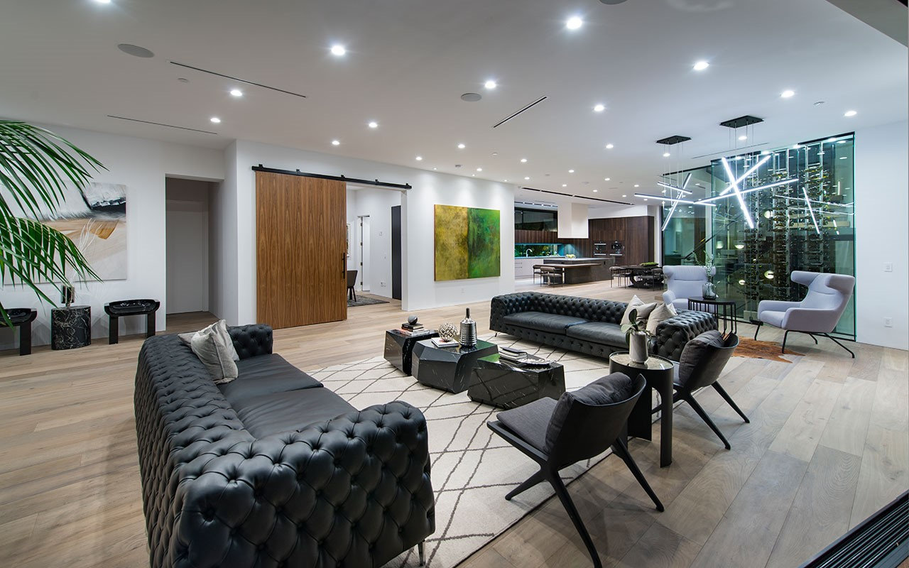 Living room at Shoreham with glass wine wall and wood sliding door, by Apel Design