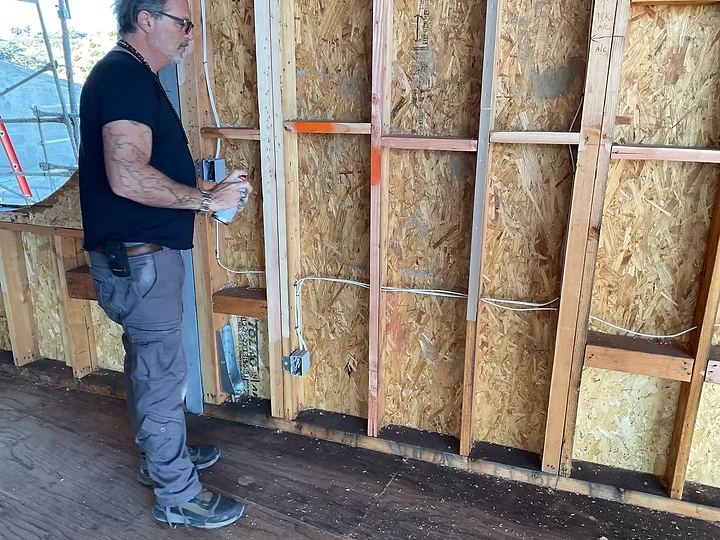 Working at a sheathed wall inside a residence