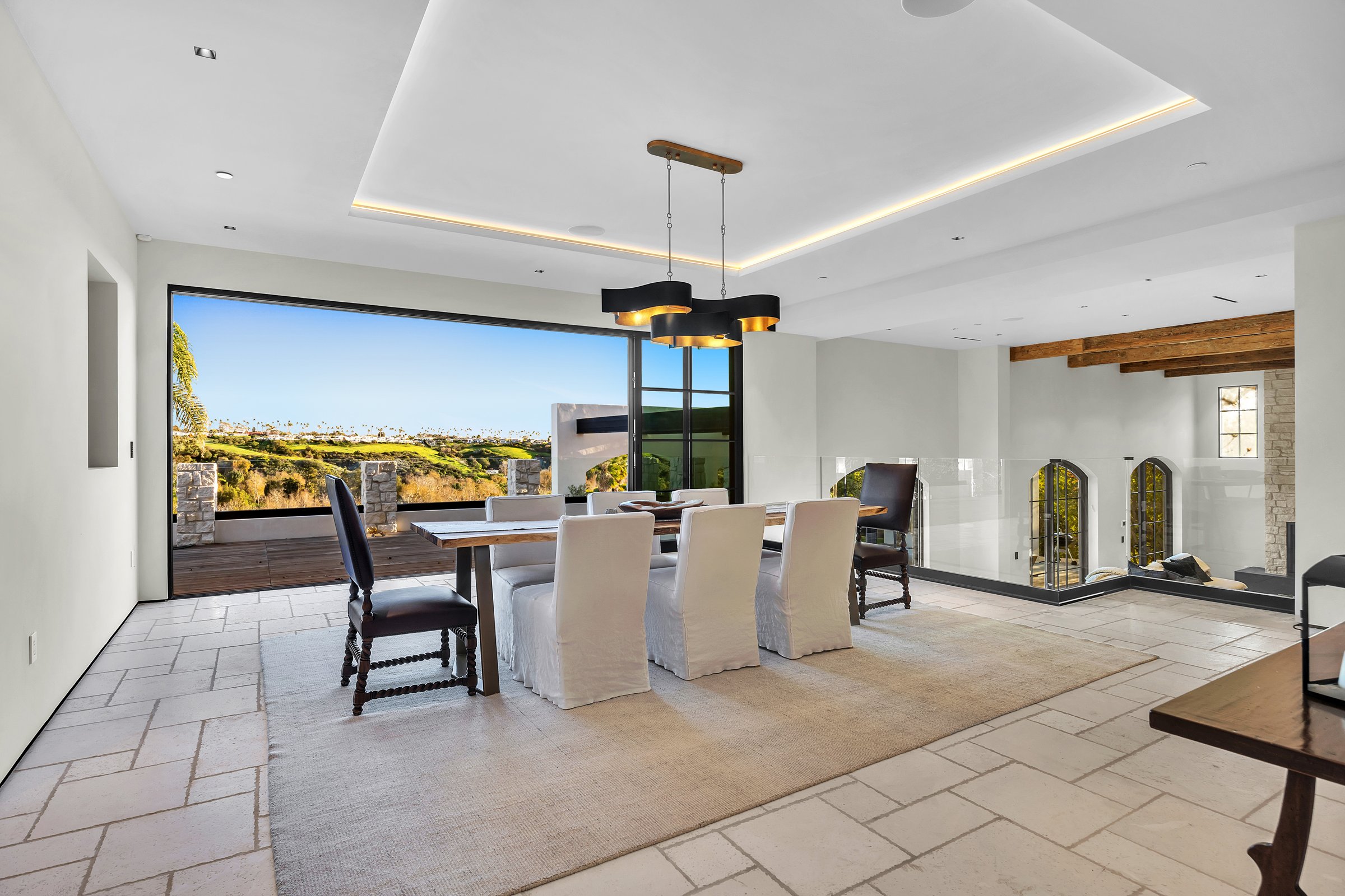 The dining room, with a corner of glass that slides fully open to the terrace, Merritt Estate in Malibu by Apel Design