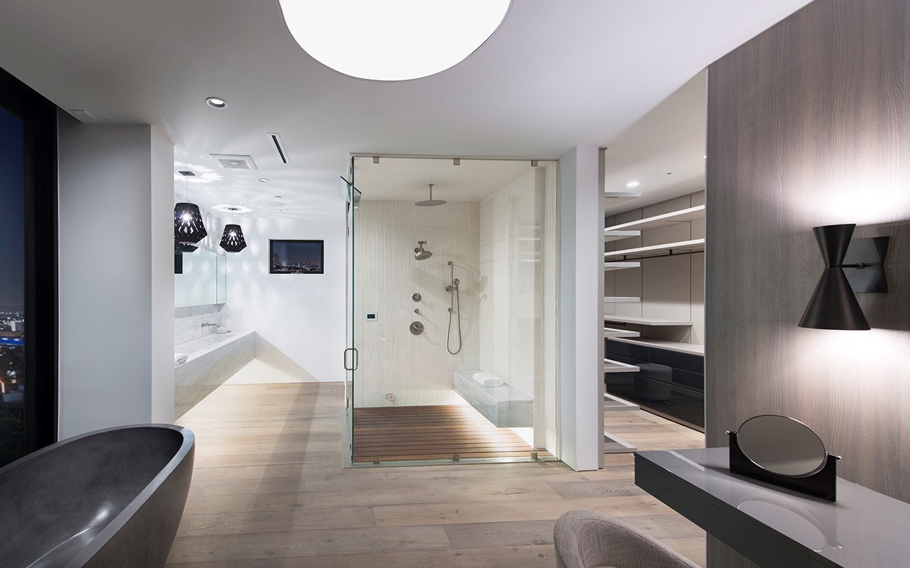 Glass-enclosed shower with wood floor in the bathroom at Shoreham, by Apel Design