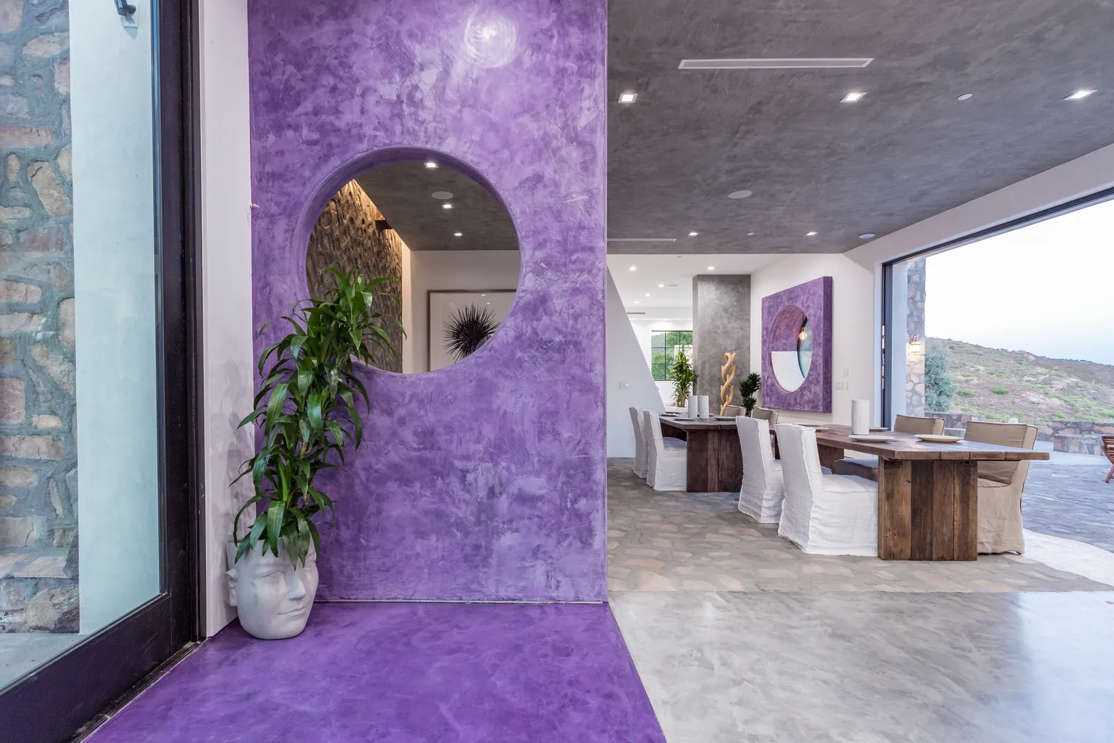 Plum plaster entry wall and dining area in an Apel Design design-build residence