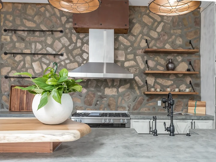 Stone wall and copper hood in the kitchen at Maliview