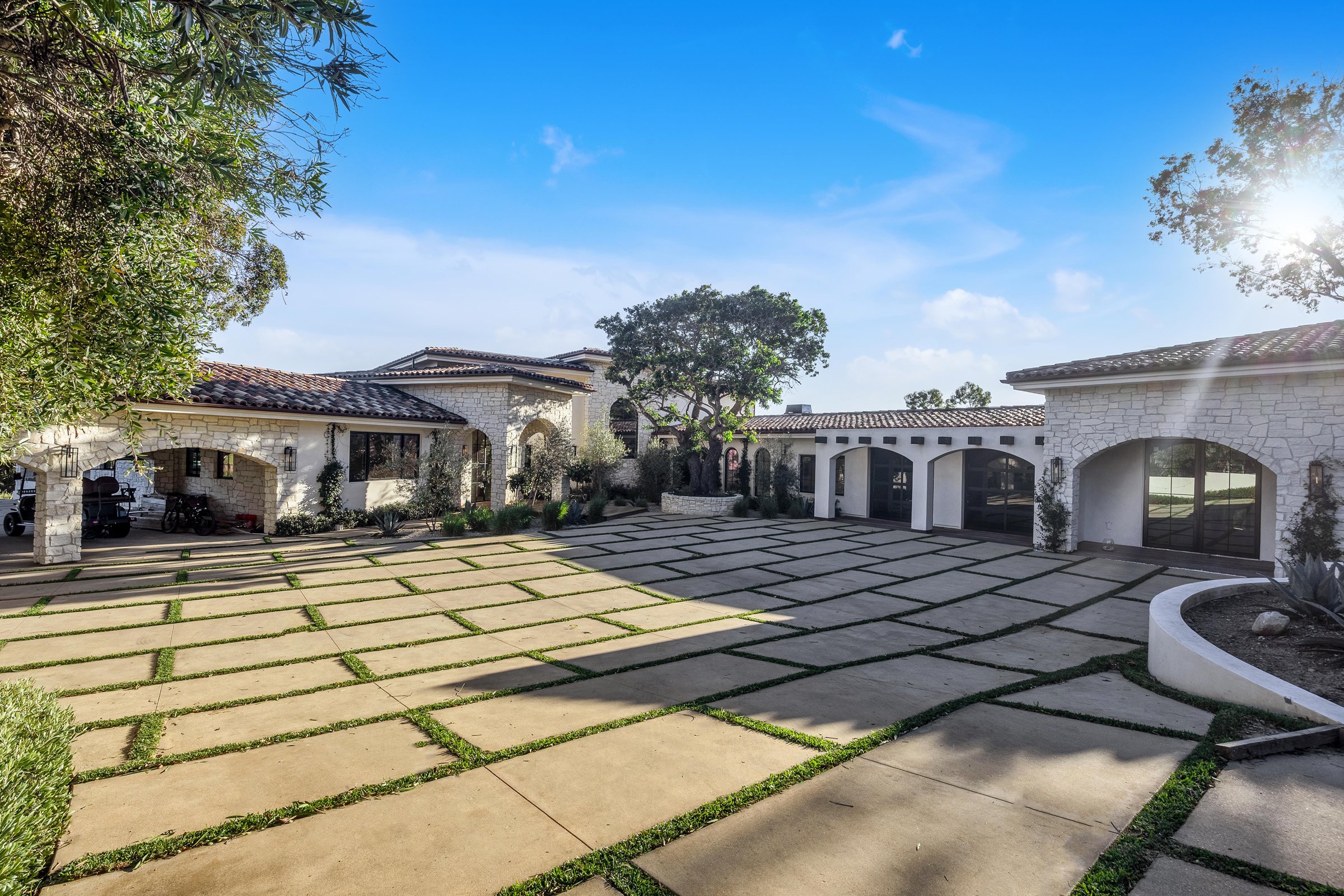 Arched garage bays along the motor court, Merritt Estate in Malibu by Apel Design