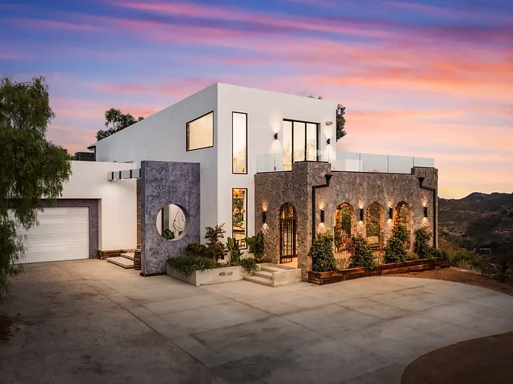Stone and stucco residence in the Malibu Mountains at dusk