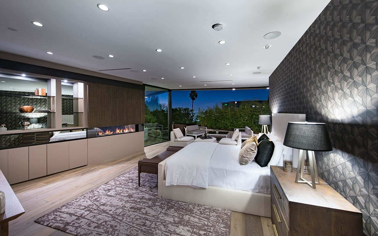 Bedroom at Shoreham with linear fireplace and corner glass to the terrace, by Apel Design