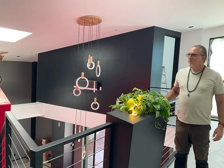 Reviewing a ring chandelier above a stairwell