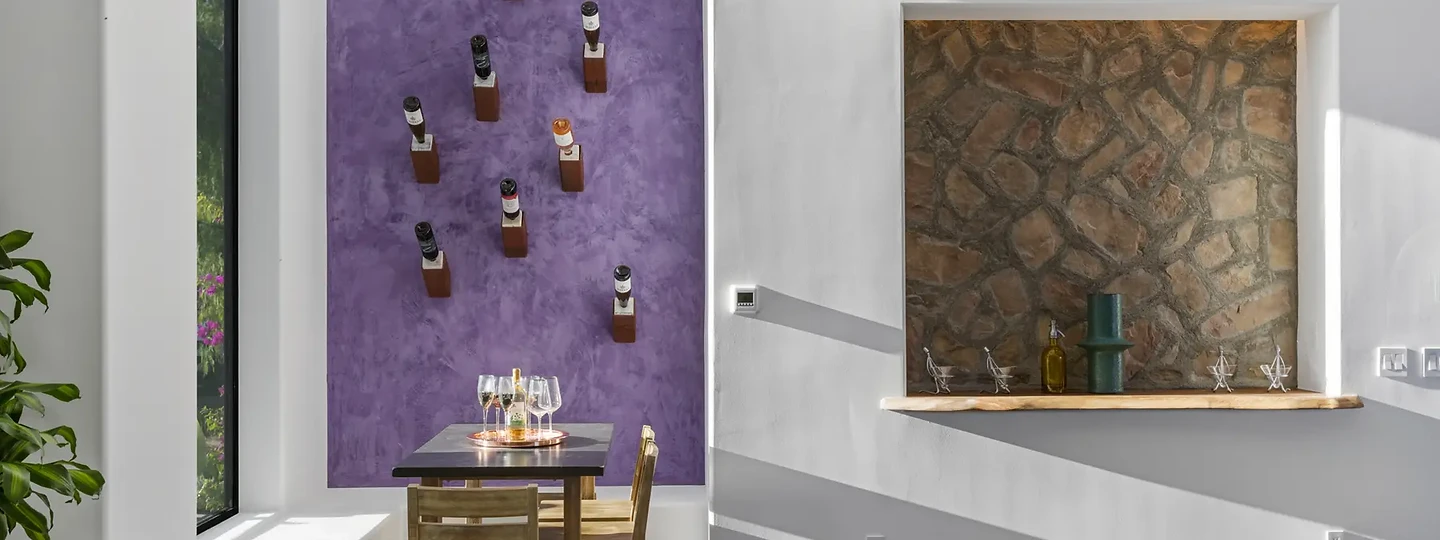Plum wall and stone niche in an interior at Maliview