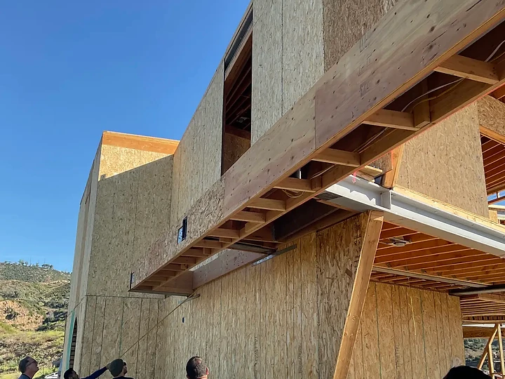 The team reviewing a sheathed elevation on site