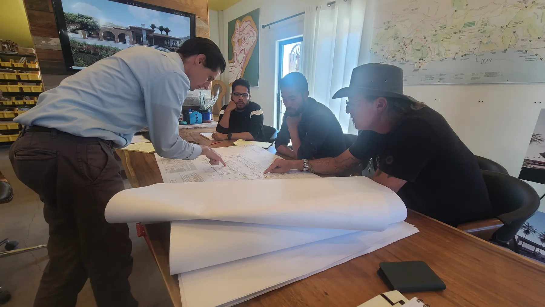 Working through rolled construction documents at the studio