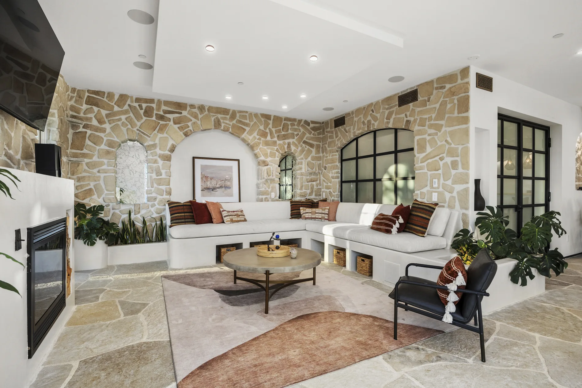 Living room and fireplace composed through material, art and light