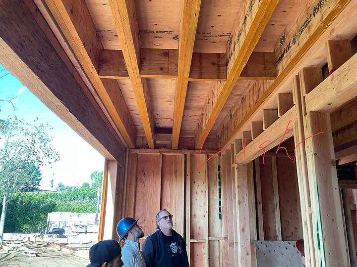 The team beneath completed roof framing