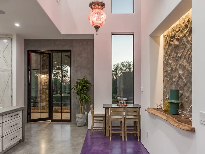 Entry at Maliview with a pendant lamp and plum floor