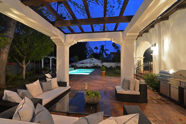 Loggia at June under a timber pergola, with the outdoor kitchen, by Apel Design