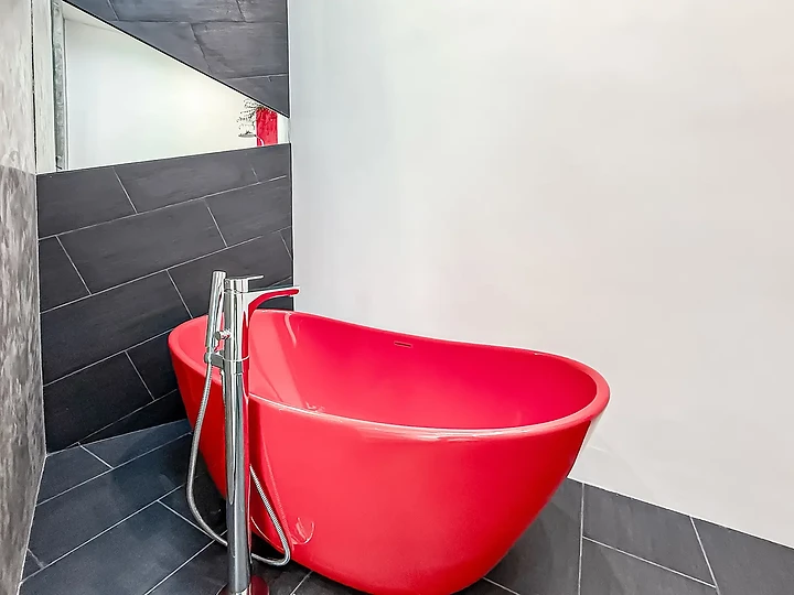 Freestanding red bathtub at The Aviator