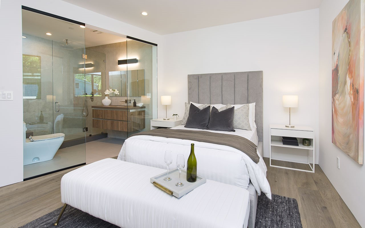 Bedroom at Shoreham with glass-walled bath and freestanding tub, by Apel Design