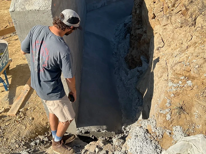 Examining a rock outcrop on a hillside site