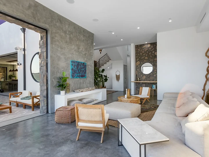 The living room opens wide to a covered patio, at Maliview in the Malibu Mountains, by Apel Design