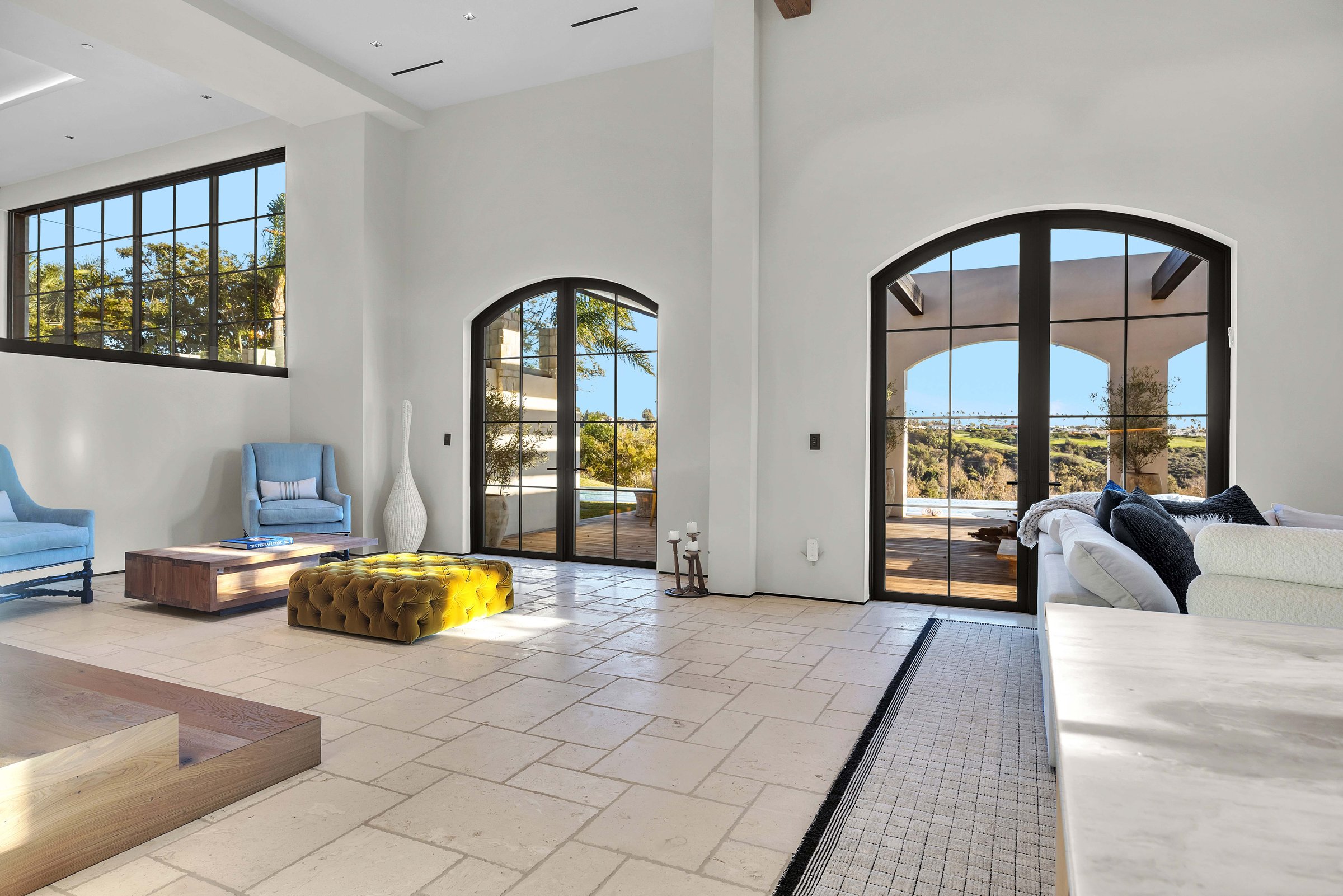 Arched steel doors opening the living room to the loggia, Merritt Estate in Malibu by Apel Design