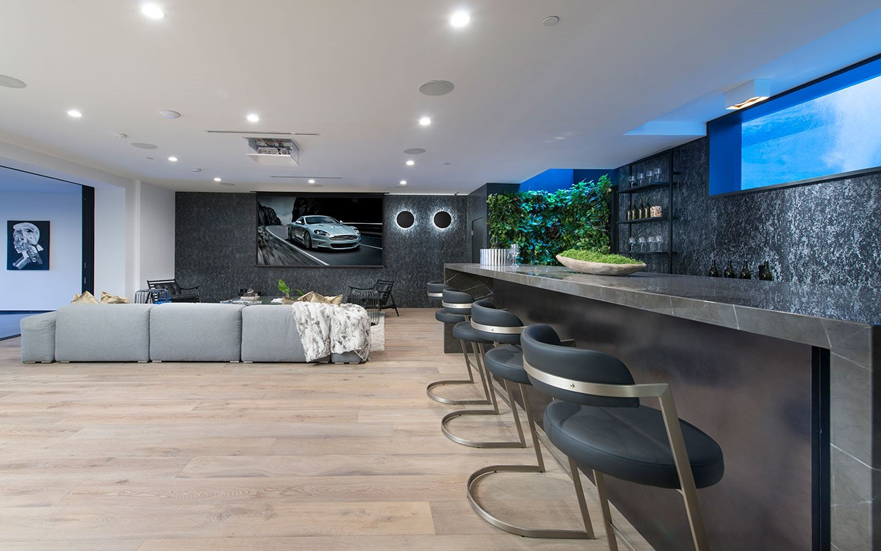 Lower-level bar at Shoreham with stone counter and living green wall, by Apel Design
