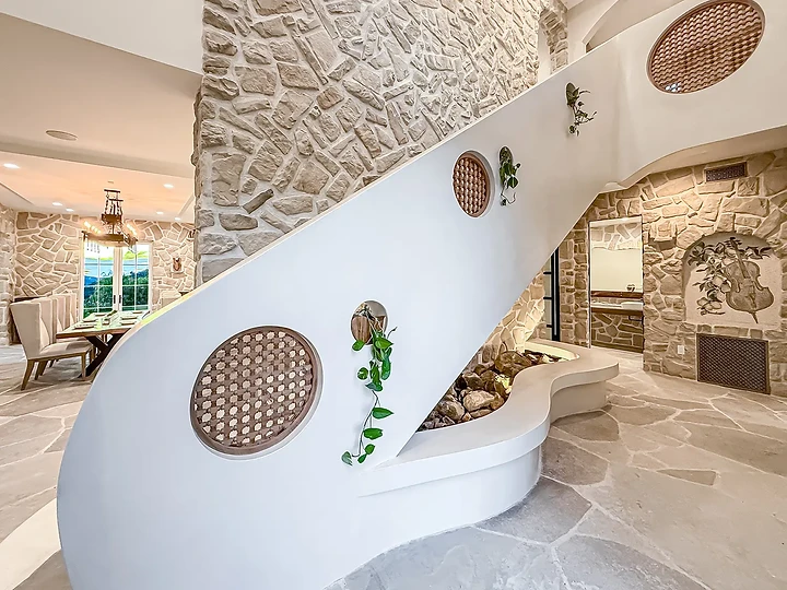 Curved plaster stair against stone at Mintcello