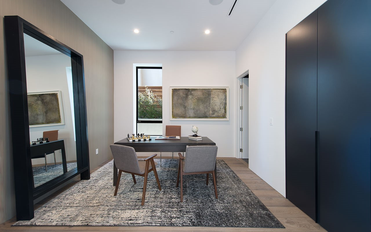 Study at Shoreham with oversized framed mirror and dark panelled wall, by Apel Design
