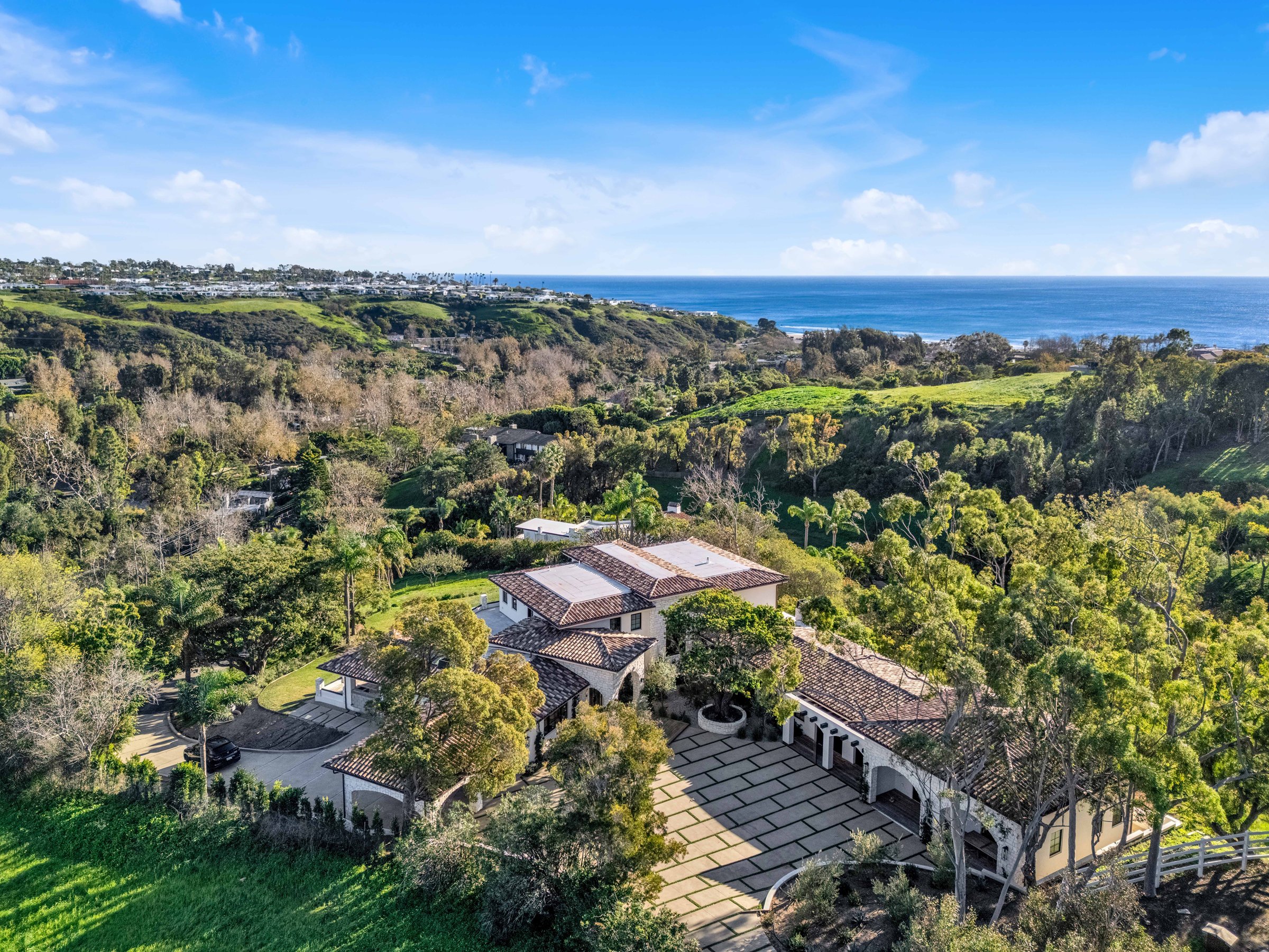 The house among mature trees above the canyon, with the ocean in view, Merritt Estate in Malibu by Apel Design