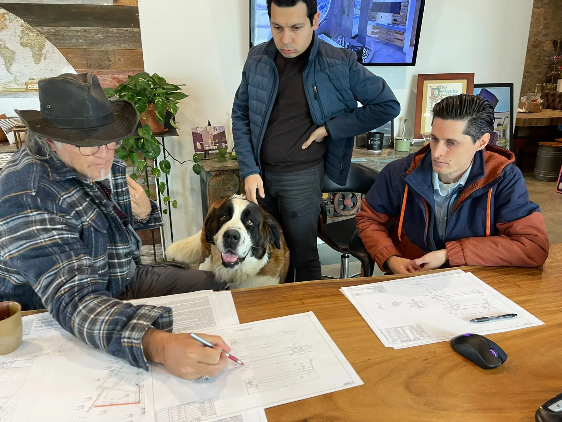 The Apel Design team reviewing construction drawings together at the studio table